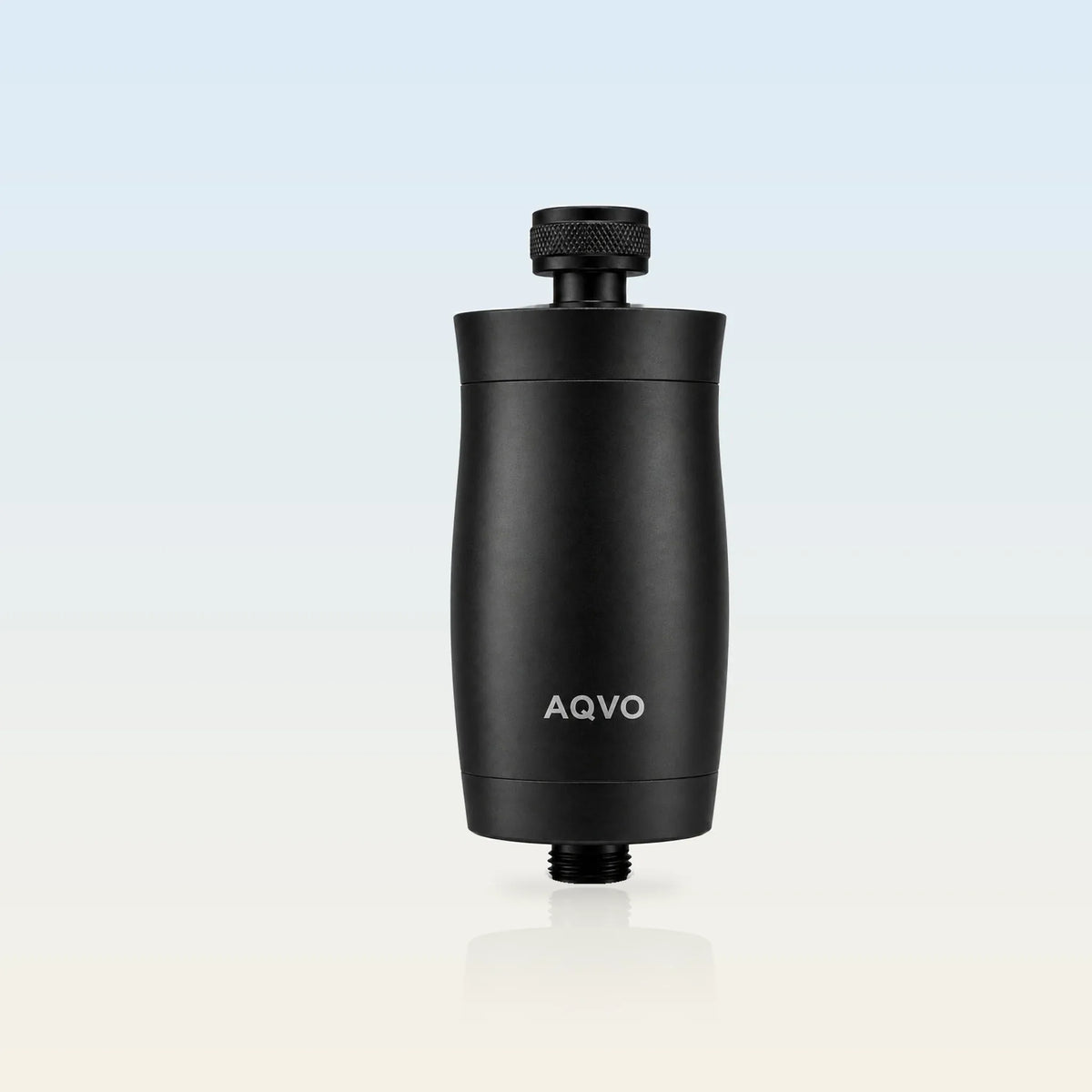 AQVO shower filter in matte black — all-aluminium inline shower filter with knurled collar and ½-inch threads (illustrative background)